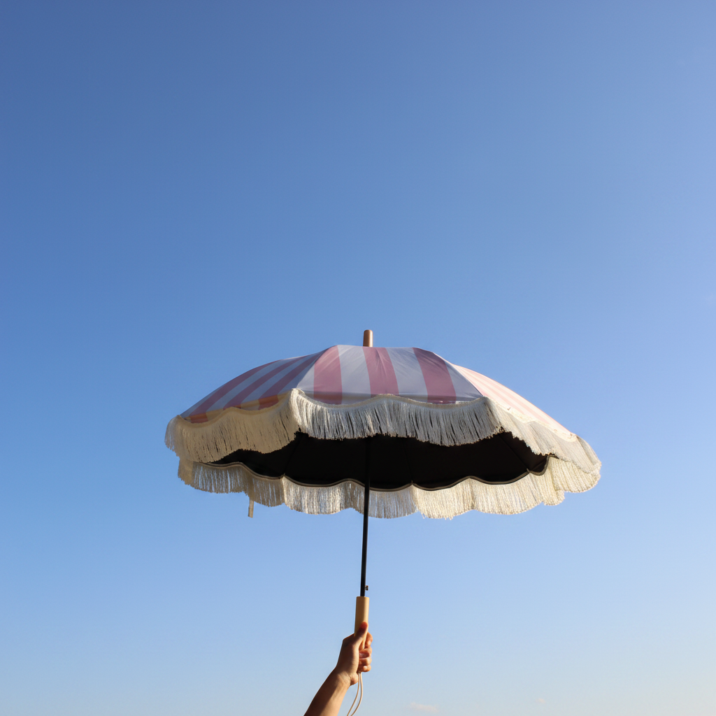 Parasol Pink parasol held against bright blue sky